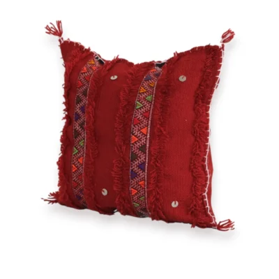 Angled view of red Moroccan Atlas Mountain wool pillow cover showing Berber tribal embroidery detail