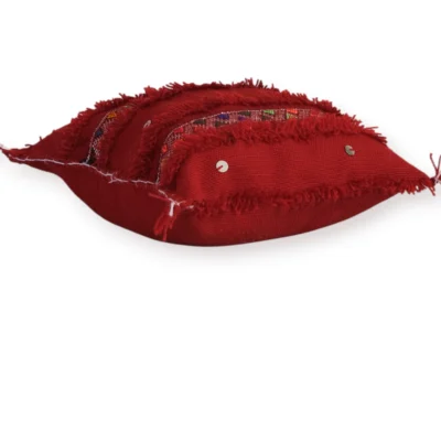 Side view of handmade Moroccan Berber wool pillow, red tribal design, Atlas Mountains, flat lay