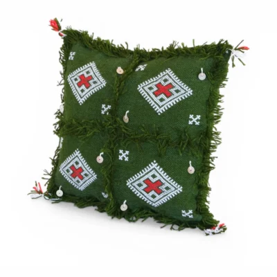 Front view of olive green Moroccan Berber wool pillow showing four red cross patterns and silver sequin charms on hand-dyed forest green wool