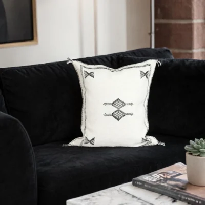 Side view of white handwoven Moroccan cactus silk pillow cover with fringe