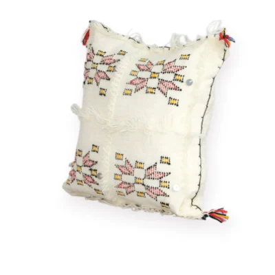Angled view of ivory Berber wool pillow handmade in Morocco