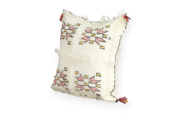 Angled view of ivory Berber wool pillow handmade in Morocco