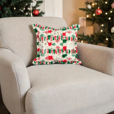 Khenifra pillow styled on a neutral armchair in a cozy living room setting
