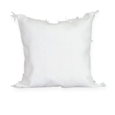 Close-up white wool fringes and silver mdebja sequins Moroccan Berber Handira pillow Khenifra