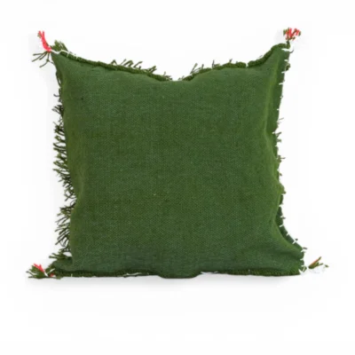 Side view of olive green Moroccan wool pillow showing dimensional thickness and long hand-spun fringes texture detail