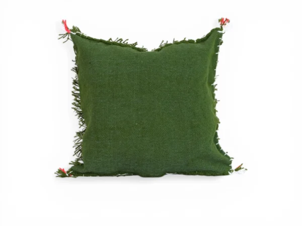 Side view of olive green Moroccan wool pillow showing dimensional thickness and long hand-spun fringes texture detail