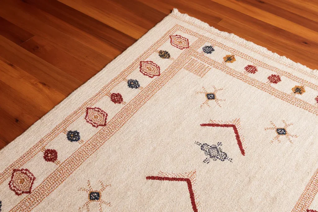 Handwoven Azilal rug with diamond motifs on an ivory wool field