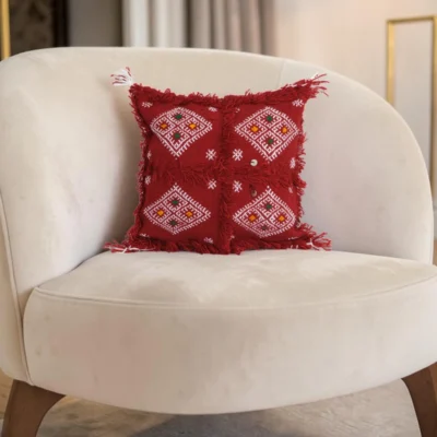 Pair of Moroccan red Berber pillows on white armchair bohemian decor