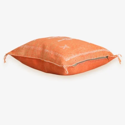 Side view of terracotta Moroccan pillow cover showing zipper closure and hand-woven Sabra cactus silk texture