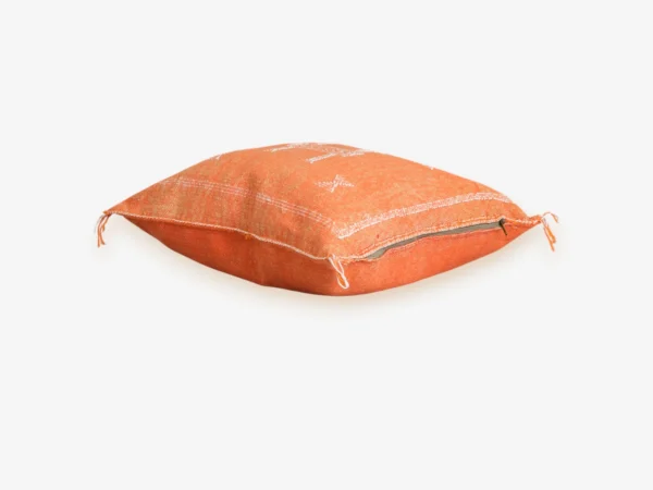 Side view of terracotta Moroccan pillow cover showing zipper closure and hand-woven Sabra cactus silk texture