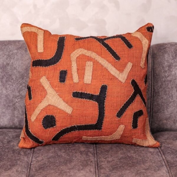Handmade rafia cushion 20×20 with terracotta ground and écru-charcoal hand-appliquéd glyphs – Tigemi one-of-a-kind Marrakech
