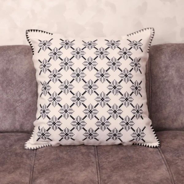 Luxury Fassi embroidered pillow 20×20 in ivory linen with all-over charcoal star pattern and sawtooth border, styled on a linen sofa – Tigemi heirloom