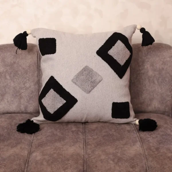 Hand-tufted Berber cushion cover in ivory and black with diamond geometric motifs and corner tassels – boho Moroccan home decor