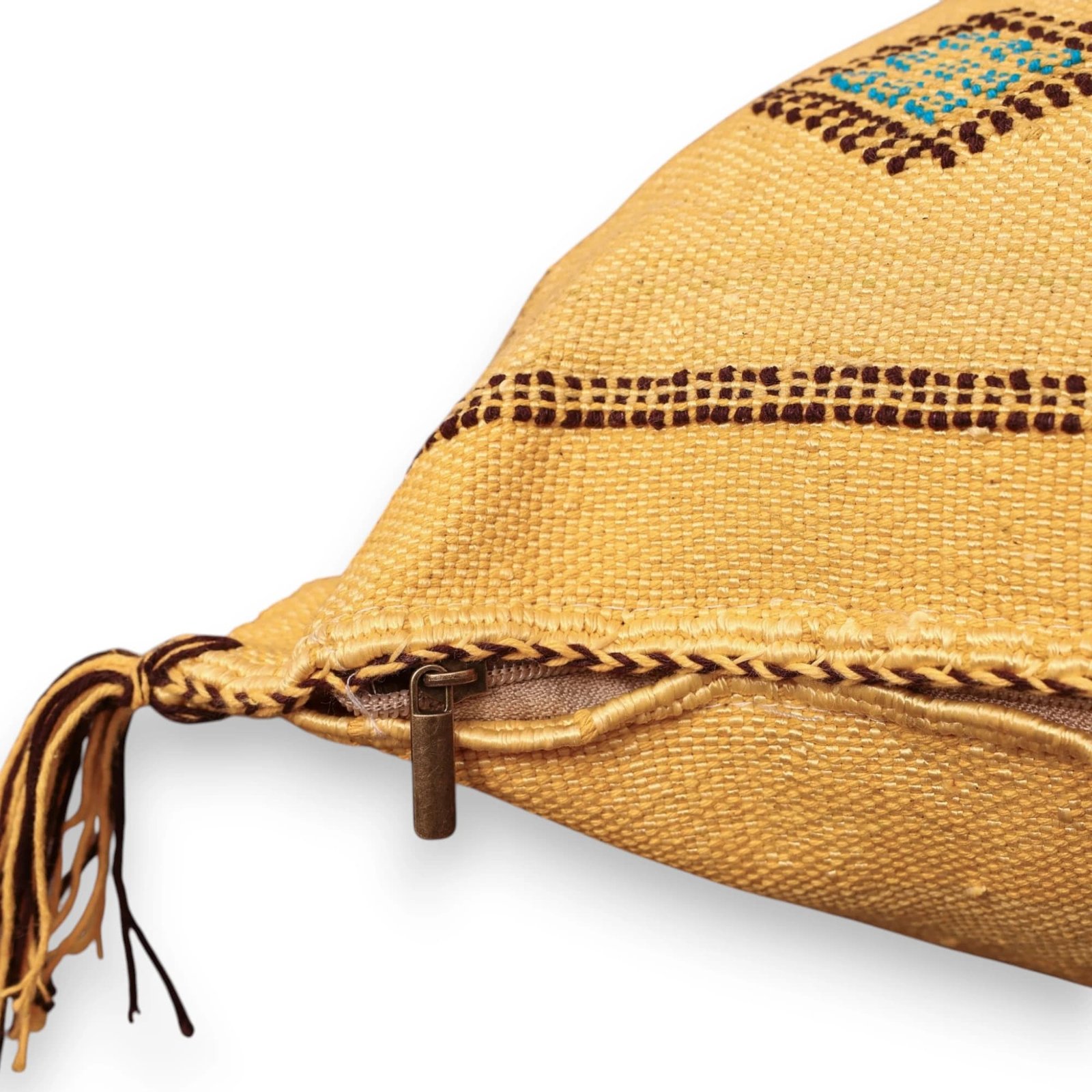 Close-up of a TIGEMI Sabra silk pillow showing handwoven texture, embroidered border, and zipper finish