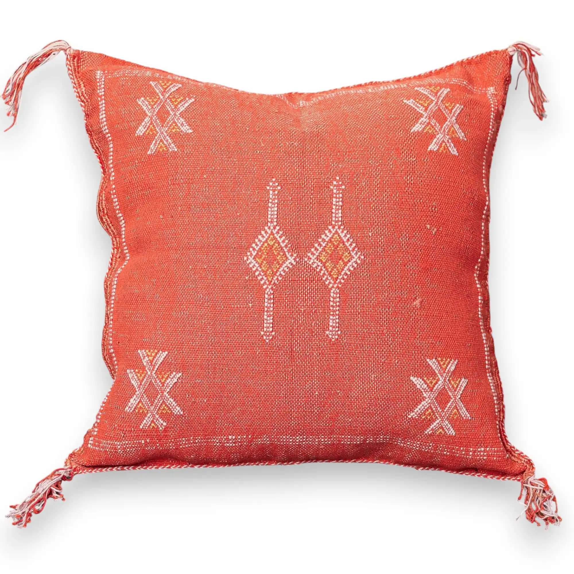 Burnt orange sabra cactus silk throw pillow cover with ivory Berber XX star motifs, a central twin-flame diamond motif, and fringed corners, handwoven in Marrakech.