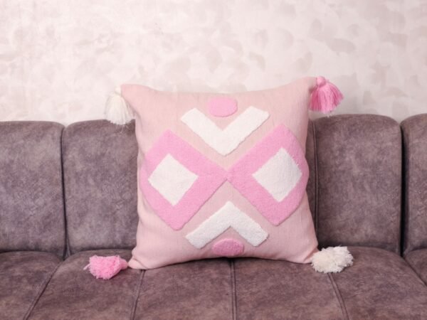 Blush Tufted Berber Pillow with tassel edge on grey sofa — handwoven Moroccan artisan cushion cover